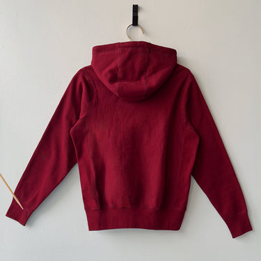 red hoodie on white wall