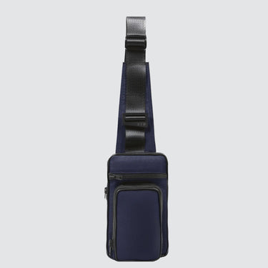 Navy blue crossbody bag with a black strap on a white background