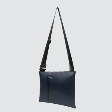 The ANDO satchel in navy vegan leather (desserto). Product shown at the front/center of a white background