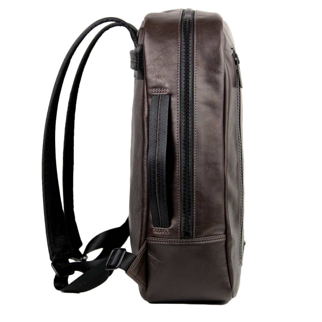 Side view of a brown leather backpack with a side-carry handle