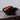 Cyrc U fruit bowl in black. 3D printed recycled plastic bowl holding peaches on a marble surface.