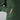 a close up of a woman's hand in the front pocket of a forest green hoodie