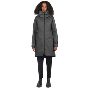 Female stands facing camera wearing a graphite parka on a white background