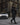 A woman confidently crosses the street wearing the Kirsi, a knee-length coat, in black