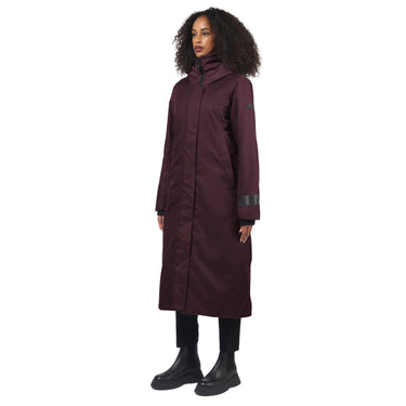 A woman wearing a long purple winter coat with high neck