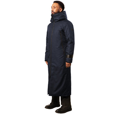 A man wearing a long navy blue winter coat with a hood and simple design