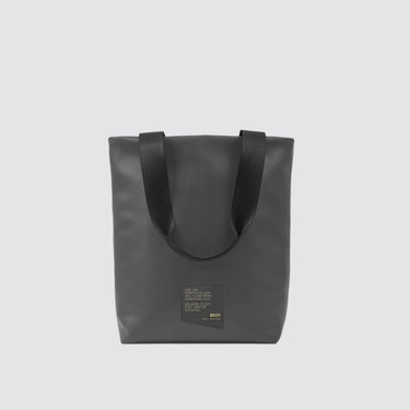 Front view of utilitarian style medium sized tote in grey vegan leather (Desserto), on white background.