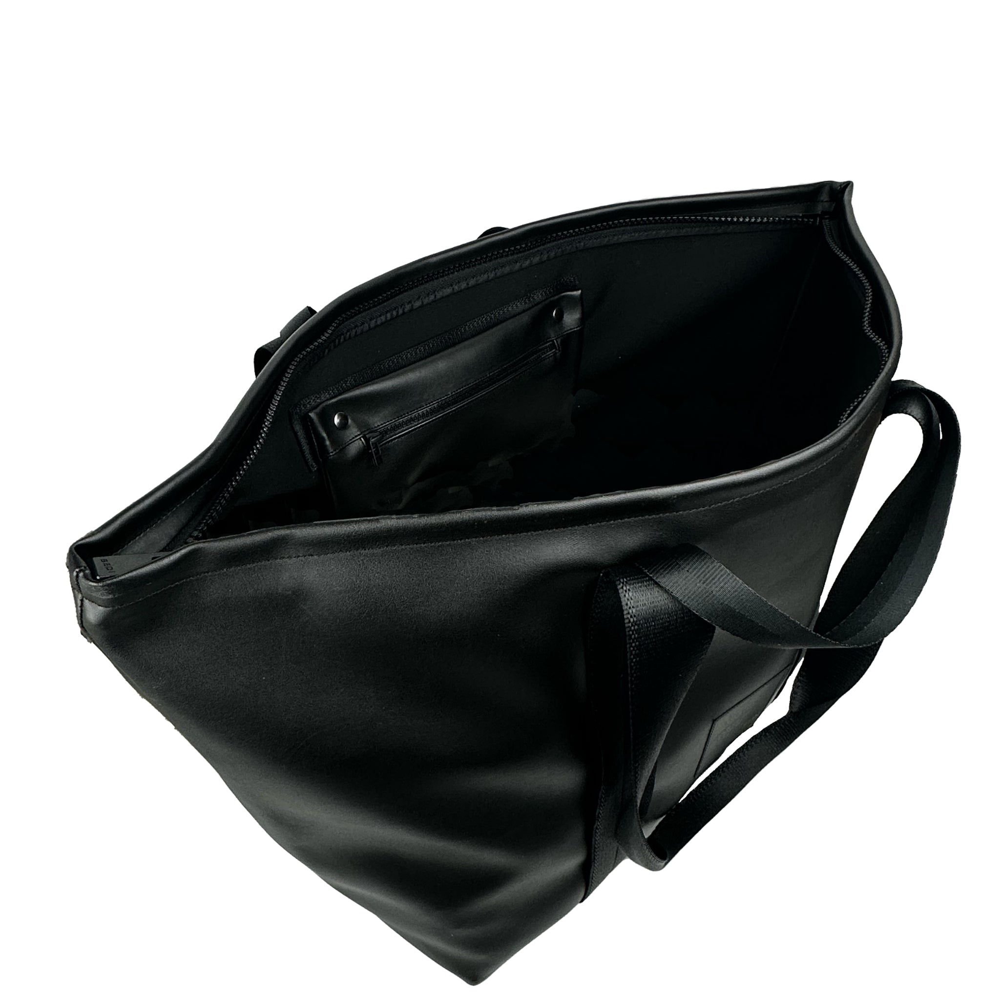 angled view of inside of a Black weekender in vegan leather (desserto) on a white background.