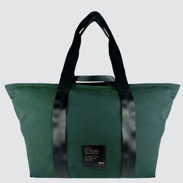front view of a duffle bag in green twill material, against a white background.