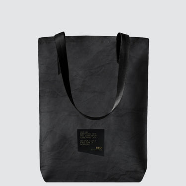 Simple black waxed canvas tote bag with black seatbelt straps