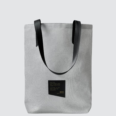 white tote bag made with textured patio furniture material and a black seatbelt strap