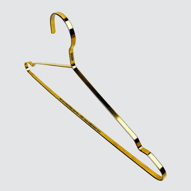 One brass engraved hanger on a white background