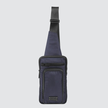 Face view of a utilitarian style sling in navy upcycled nylon material on a white background.