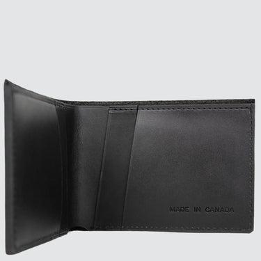 Interior of a classic black leather wallet, with four card slots