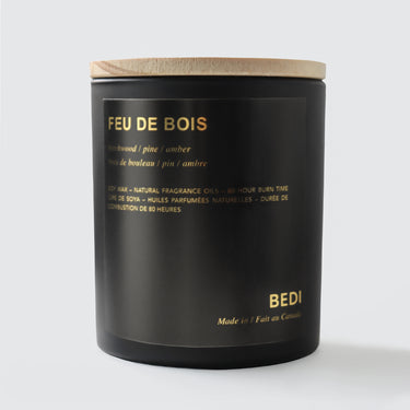 Black candle with wooden lid labeled 'Feu de Bois' by BEDI on a white background