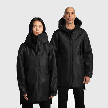 Two people wearing black hooded raincoats on a light gray background