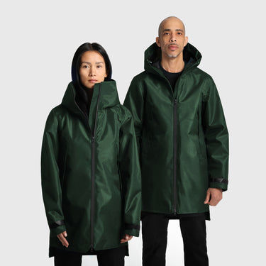 A male and a female model wearing green raincoats on a white background