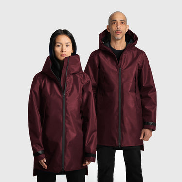 A male and a female model wearing red raincoats on a white background