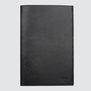 Front view of minimalist passport wallet in black upcycled leather