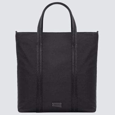 A large minimalist tote bag in black nylon material, with a black strap that runs the height of the bag