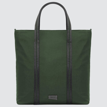 A large minimalist tote bag in green nylon material, with a black strap that runs the height of the bag