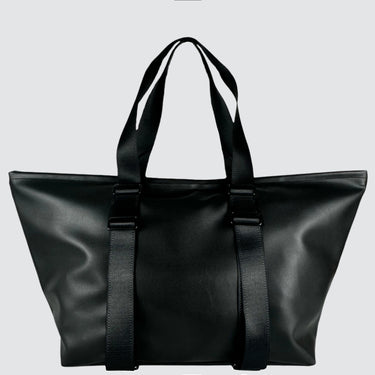 back view of a black duffle bag in vegan desserto leather