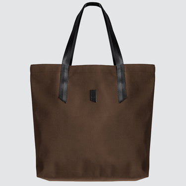 Brown tote bag with black handles on a light gray background