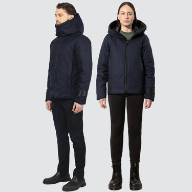 male and female model, both wearing navy bomber style winter coats in sustainable materials