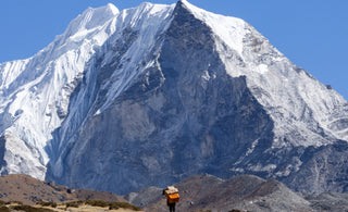 A sherpa attempting to climb the mount Everest 