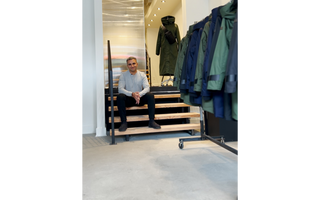 Image of the founder of bedi Studios; Inder Bedi sitting on the stairs of his first flagship store in Montreal