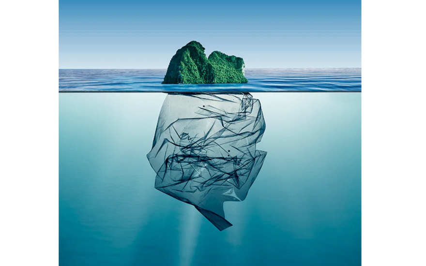 an image of the sea where above rises a mountain and below is the image of a plastic bag underneath the water