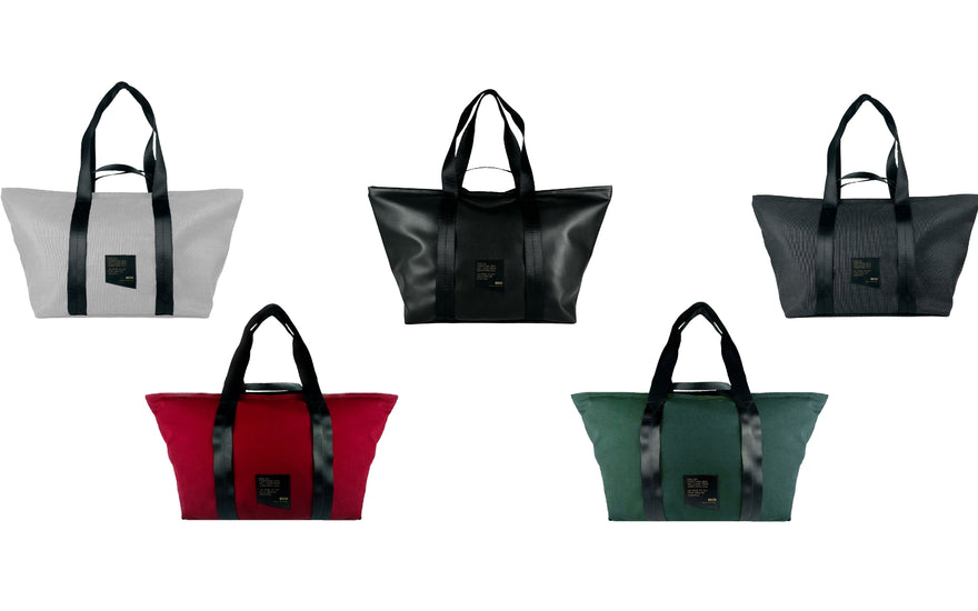 flat lay of the color variety of a recycled weekender bag on a white background. (from left to right) ghost, red, black, evergreen, graphite.