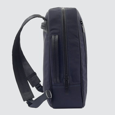 Navy CHE backpack in econyl side view in front of a white background