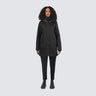 woman wearing a black coat on a white background
