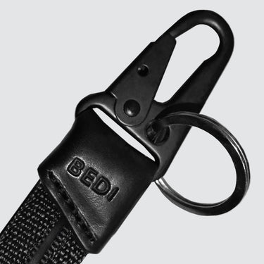 Dixon durable keychain made econyl and upcycled leather black. Close u on the hardware on white background.