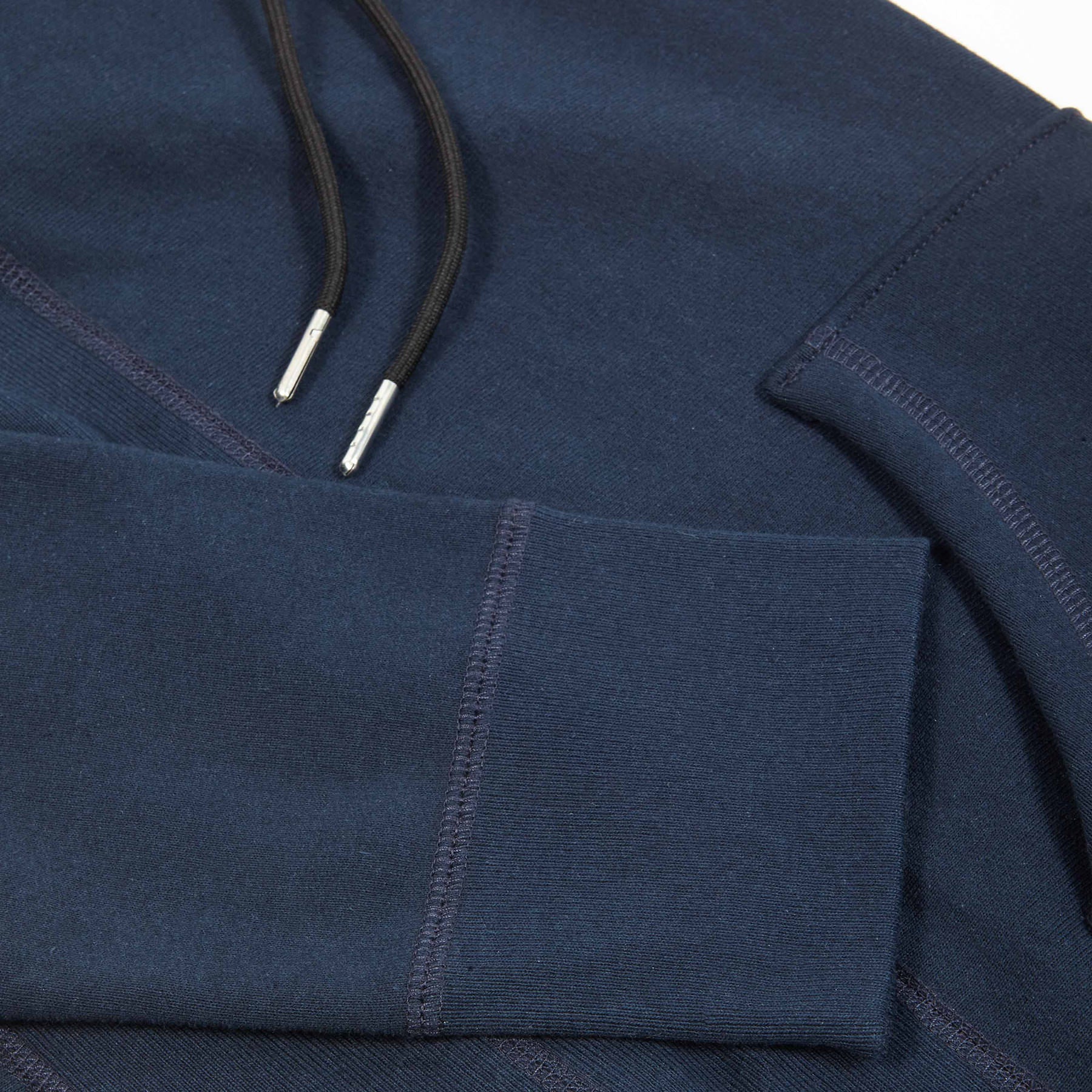 Drawstring and metal aglet detail on navy hoodie