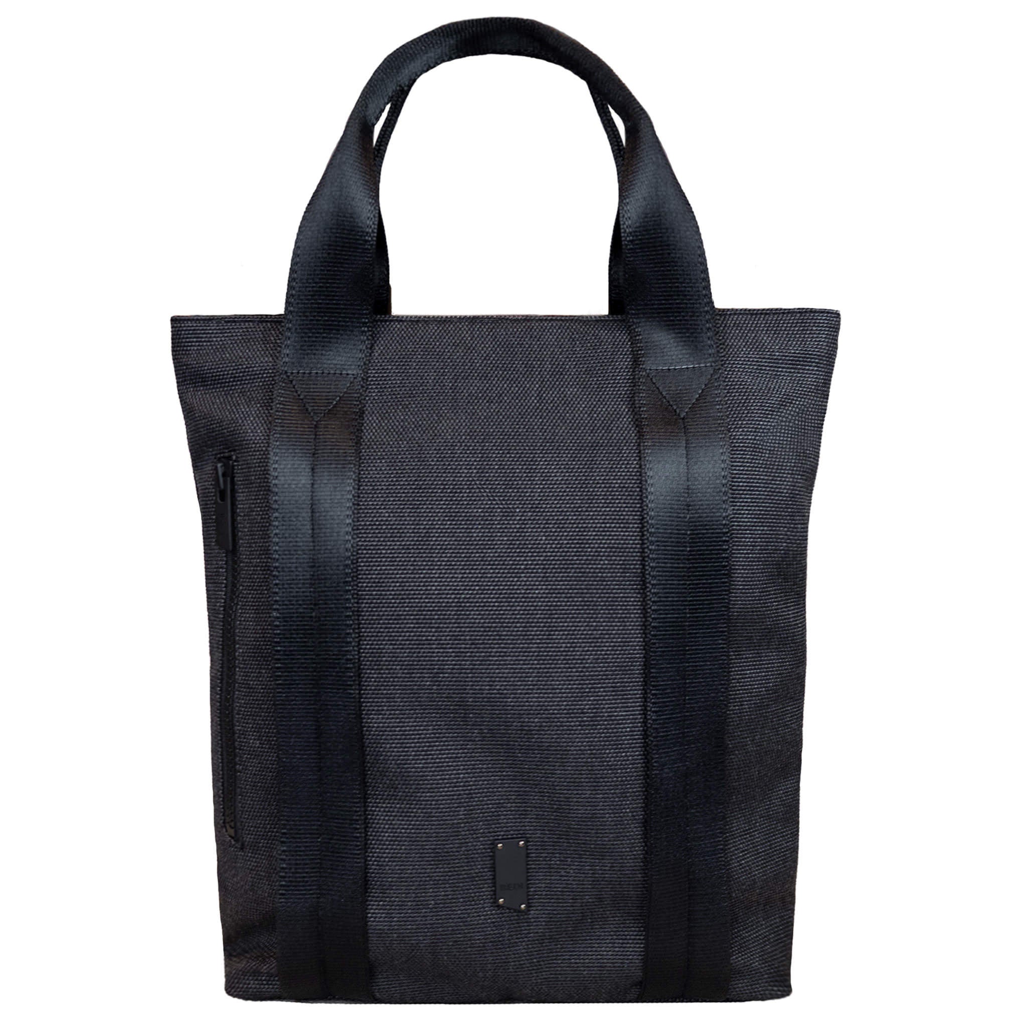 Tote bag made with grey twill material. There is a vertical black zipper on the left side, and the black seatbelt straps continue all the way down the front of the bag