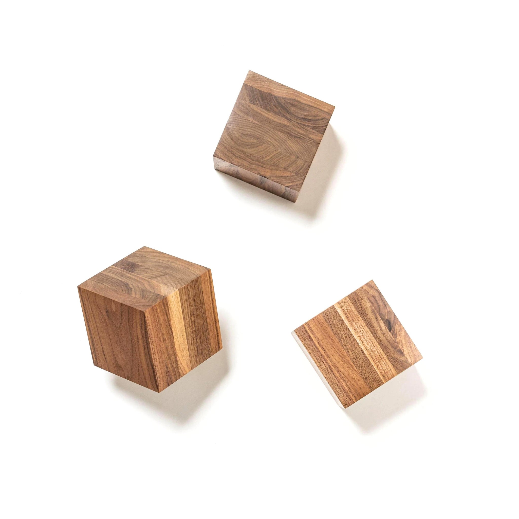 Juxstaposition of brown wooden small boxes used for presentation, on a white background.