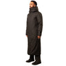 A man wearing a classic long black winter coat with a hood