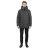 male model stands facing us, wearing a graphite utilitarian style waist length jacket on a white background.