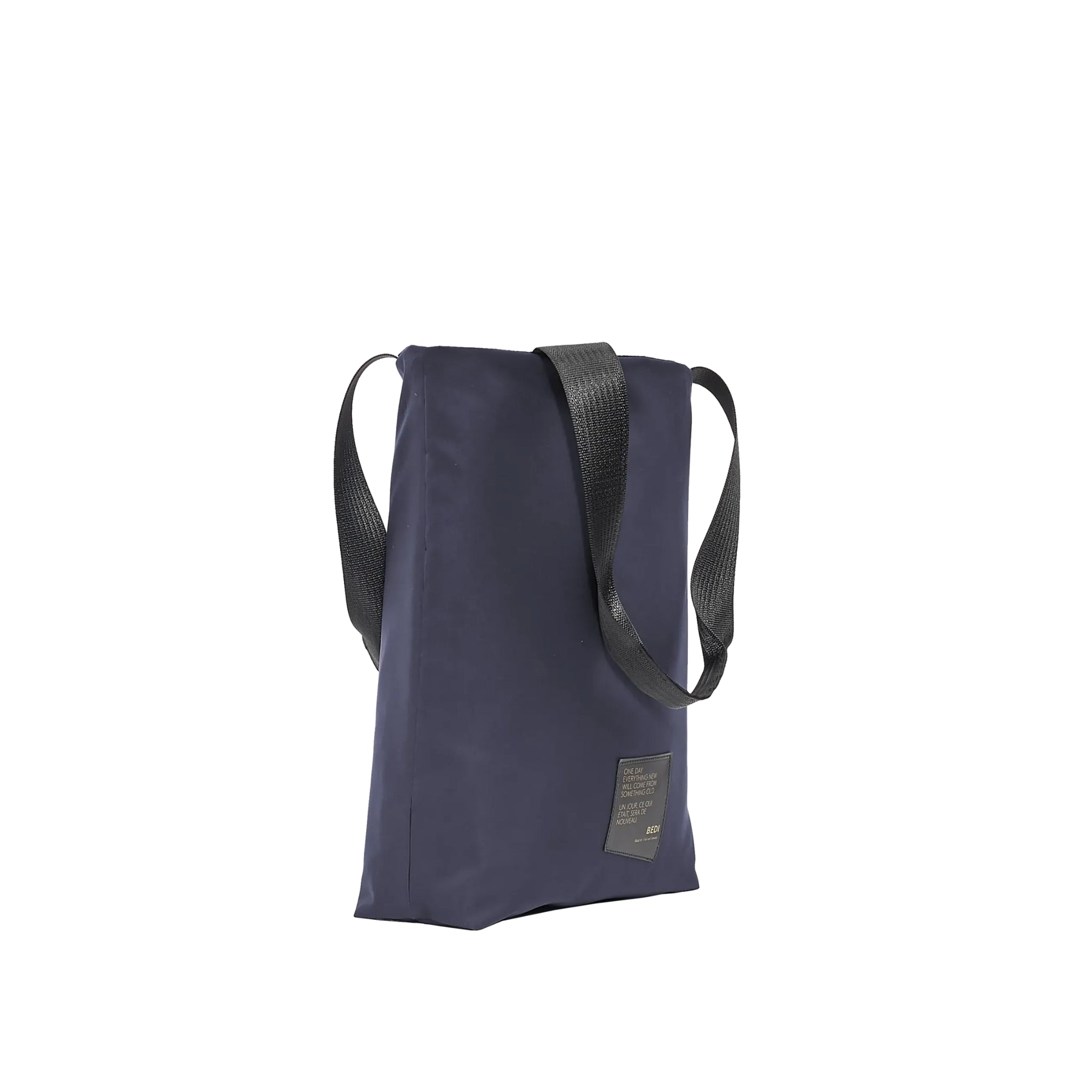 side profile of utilitarian style medium tote bag in deastock navy nylon, on a white background.