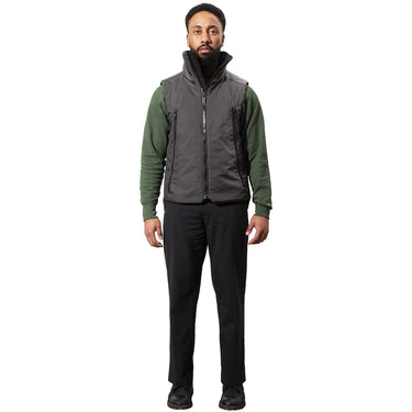 A man models a grey utilitarian vest with a high neck and zip pockets