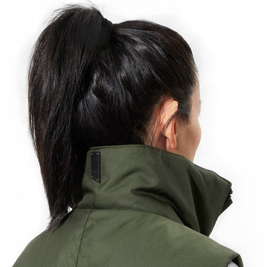 Close up view of the high neck of the green Montcalm vest, on a female model