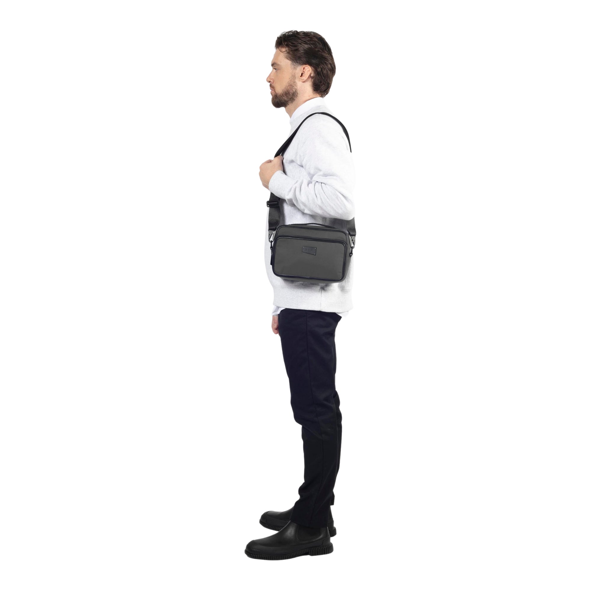 male side view of a Bedi' "second life" program grey camera bag against a white background