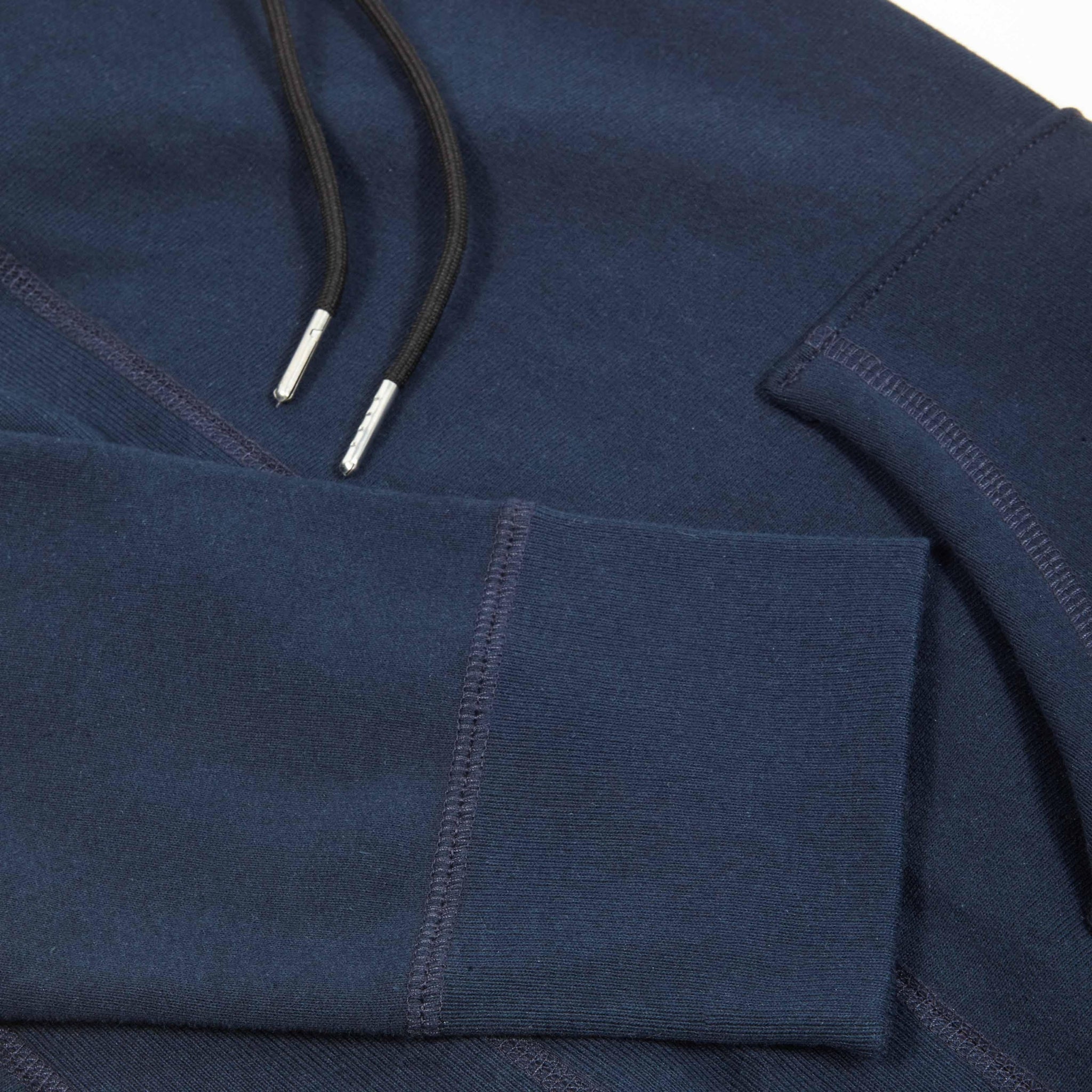 detailed hardware and sleeve view of a Bedi' "second life" program navy hoodie against a white background