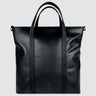 A medium-sized black leather tote bag made with upcycled leather and seatbelt straps