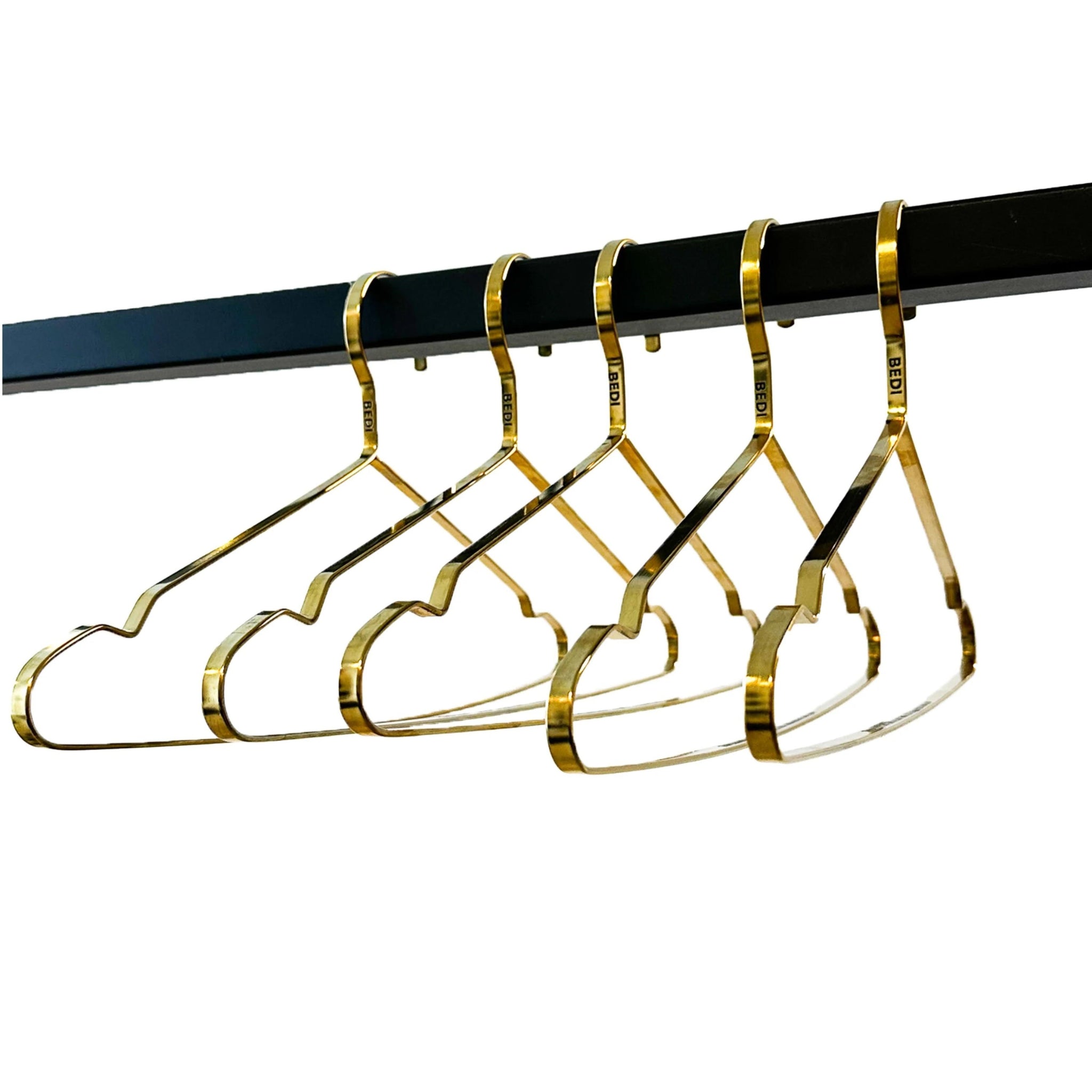 side view of five brass engraved hanger on a white background