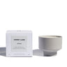 Verre Lune candle called stone (right) with its packaging (left) on a white background.