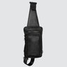 a black leather sling bag with a front pocket, middle pocket and top zip.