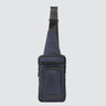 Face view of a utilitarian style sling in navy upcycled nylon material on a white background.
